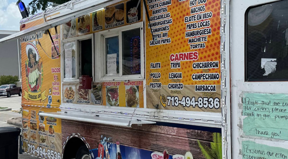 The Taquizas Ari truck with its OPEN sign lit in the service window