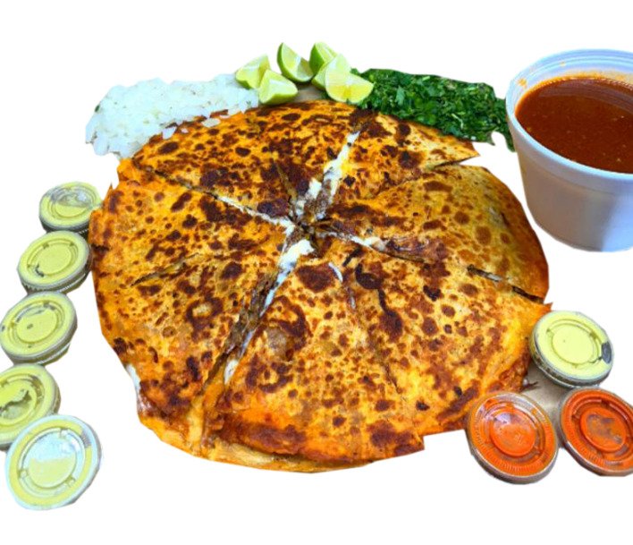 A grilled quesadilla cut into wedges with rice, cilantro, lime, and salsas