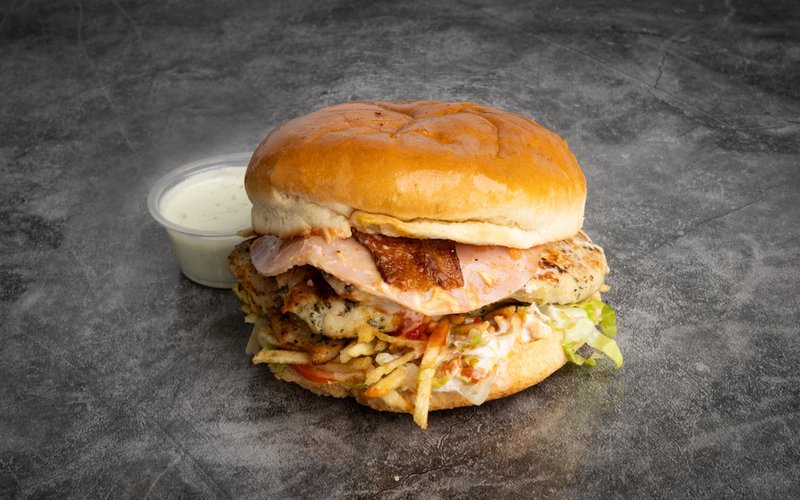 A stacked burger with cheese and ham