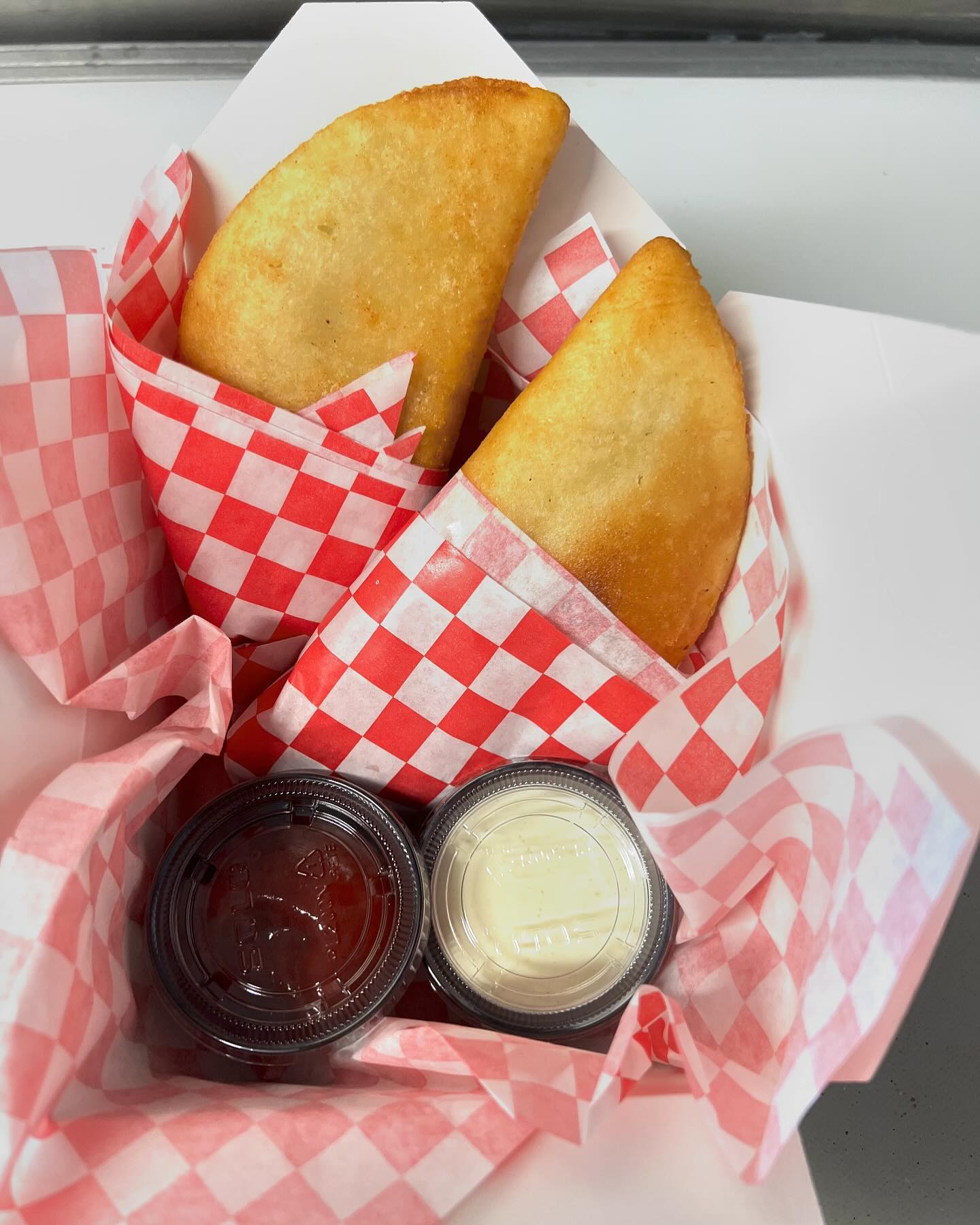 Golden empanadas served with dipping sauces