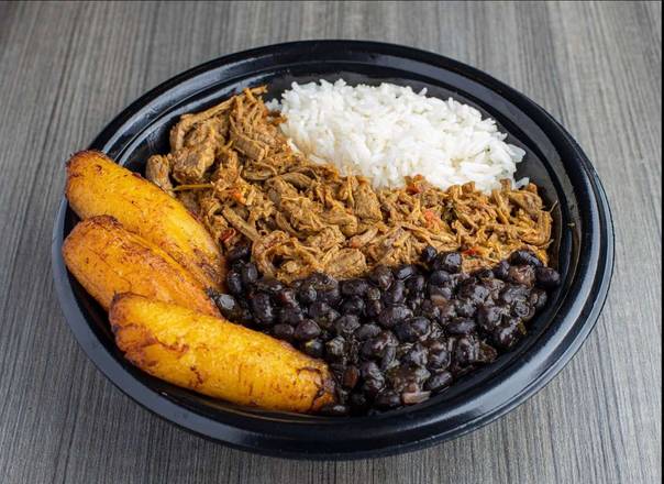 A bowl of shredded beef, rice, black beans, and plantains