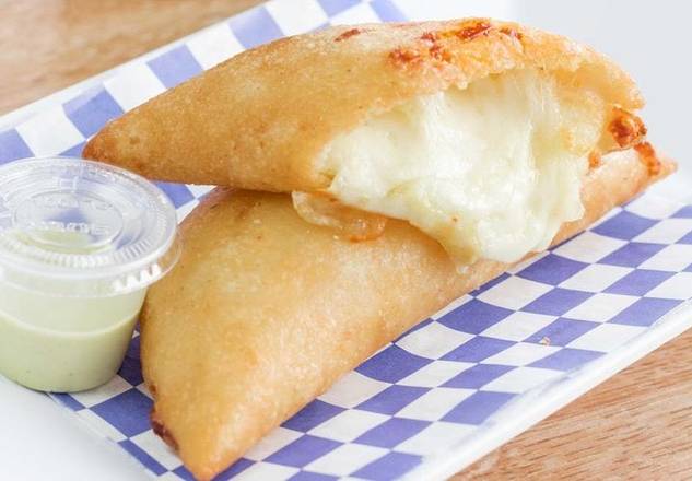 Cheese-filled empanadas with creamy dipping sauce