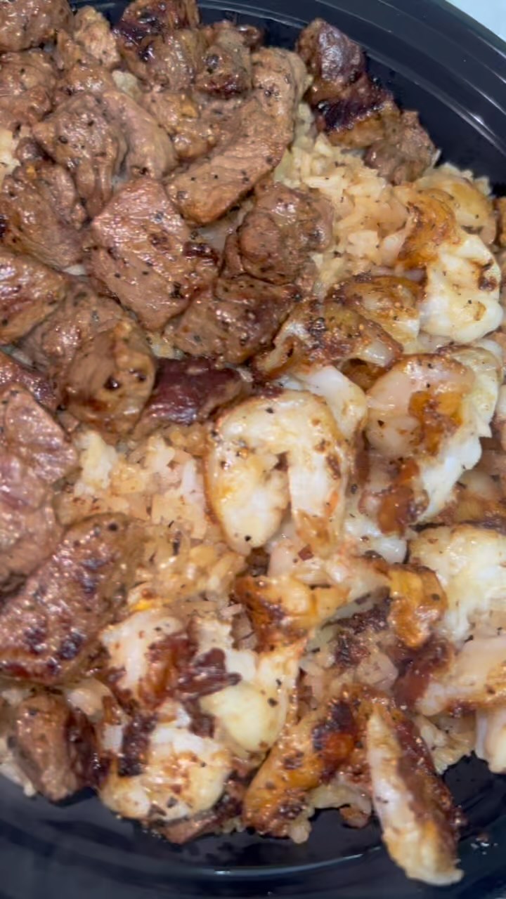 A hibachi bowl topped with steak and chicken